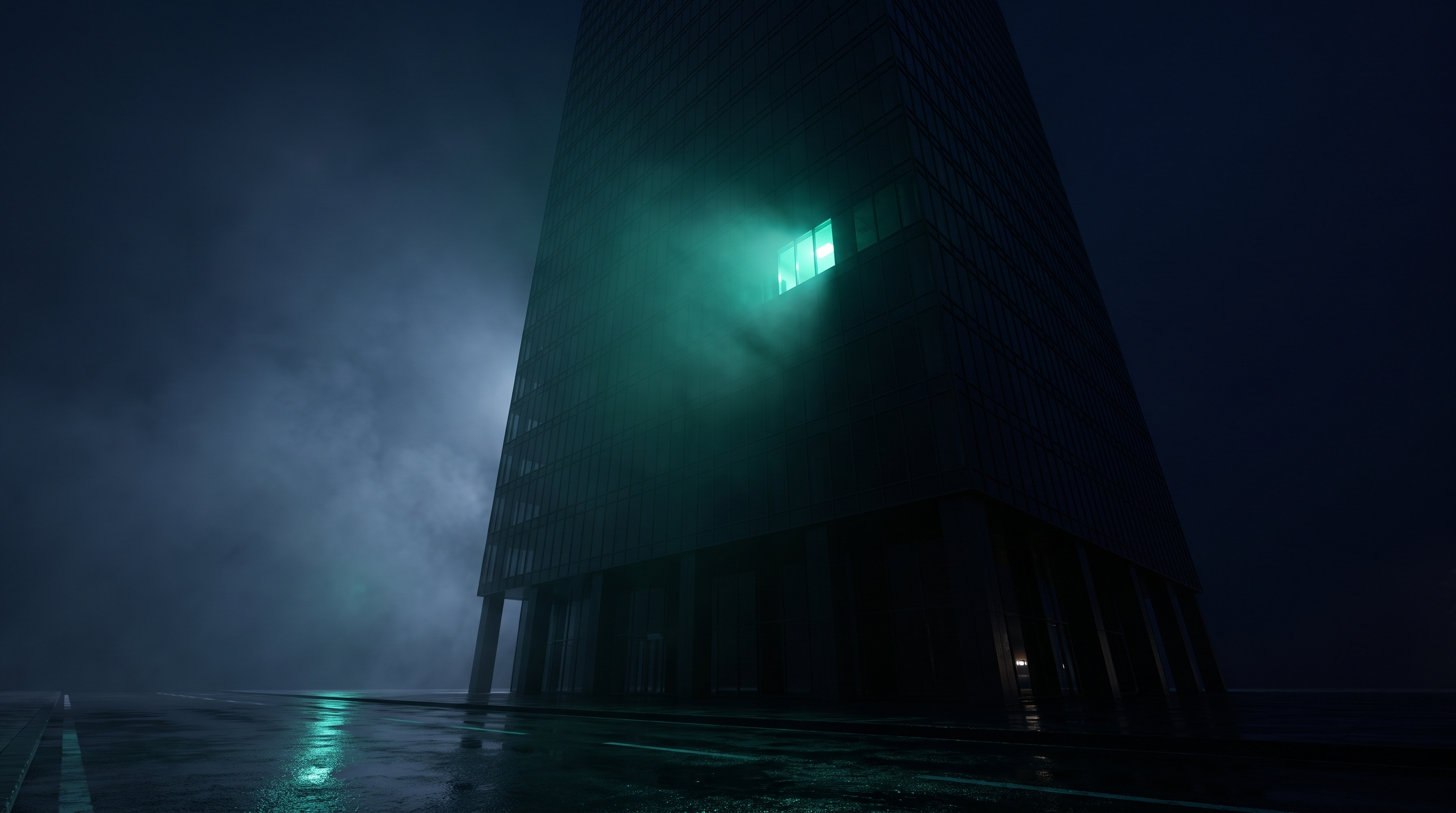 A dark glass office tower at night seen from street level in mist, every window dark except one high window glowing teal green, with its light reflected on wet pavement